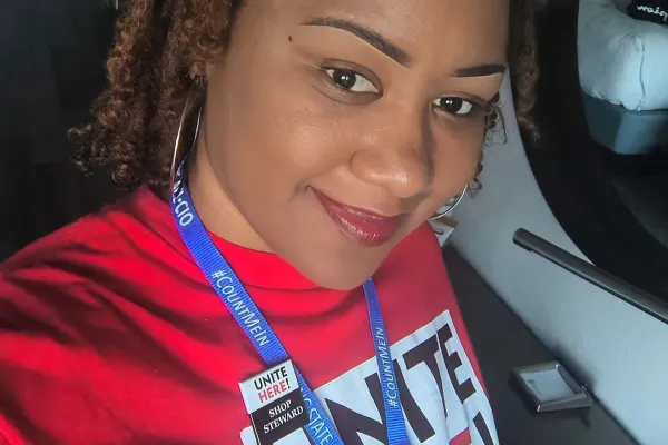 photo of Lauren Clark wearing a red UNITE HERE t-shirt and blue lanyard