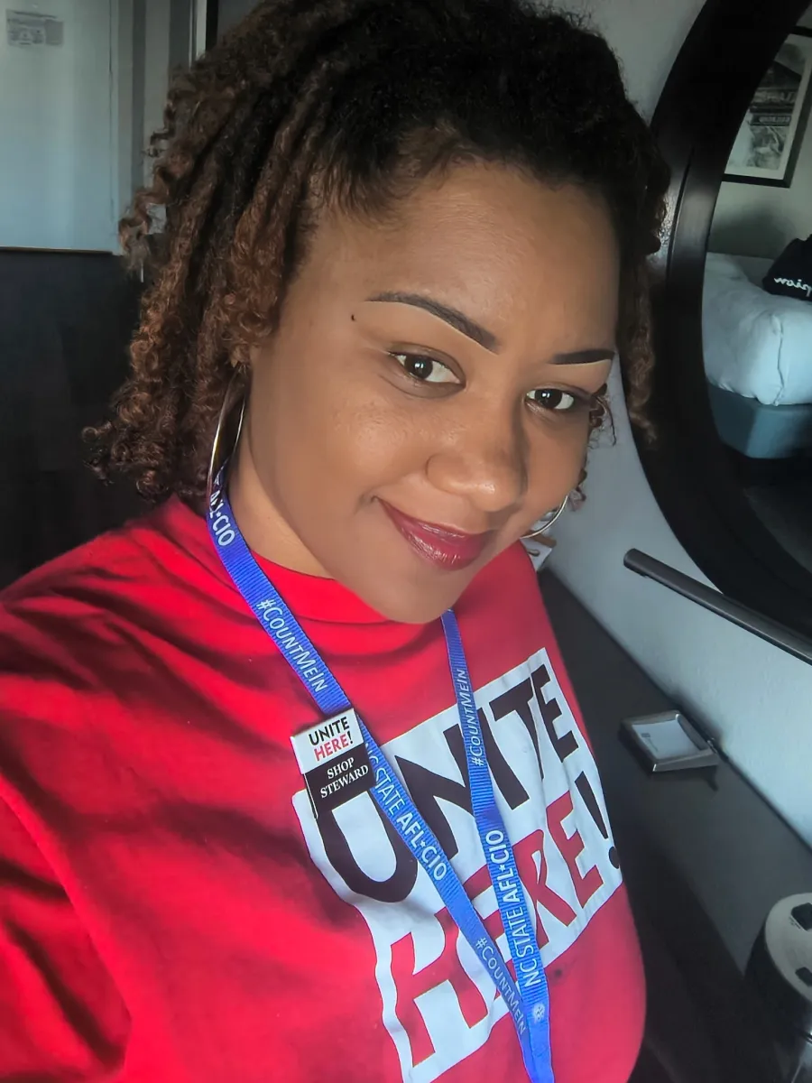 photo of Lauren Clark wearing a red UNITE HERE t-shirt and blue lanyard